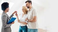 Image of happy couple collecting house keys from estate agent