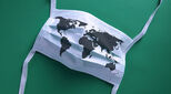 A surgical face mask with an image of a world map superimposed