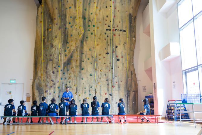 Image of XCL students by climbing wall