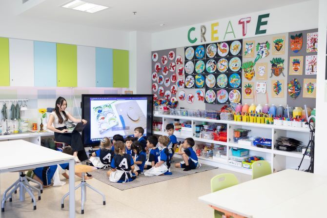 Image of students and teachers in XCL American Academy classroom