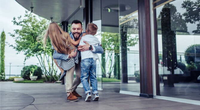 Father greeting children outside workplace