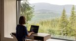 Image of woman working at desk by window