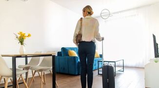 young-woman-with-suitcase-rented-apartment-image