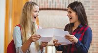 Two young people smiling with their results