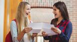 Two young people smiling with their results