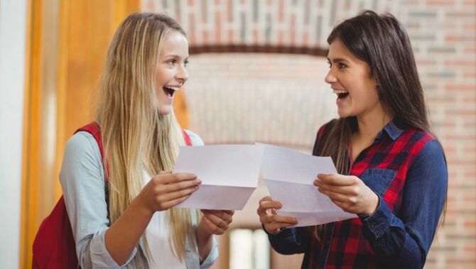 Two young people smiling with their results