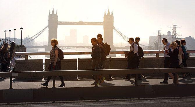 Workers and other Londoners walking over London Bridge