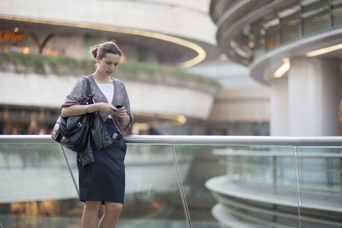 Women checks phone in urban centre