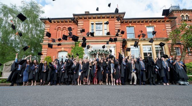 ACS-Egham-students-throwing-graduation-caps-in-celebration