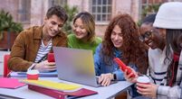 image-of-happy-students-at-laptop-phone