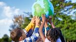 image-of-children-holding-up-globe