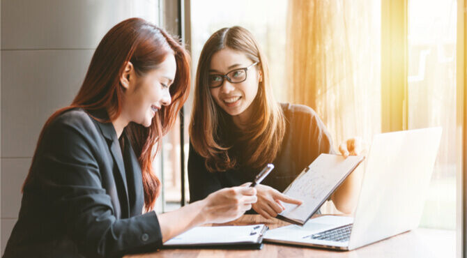 Two happy colleagues in a meeting